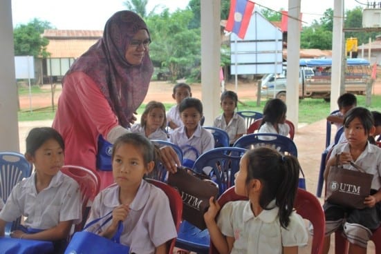 Souvenirs being distributed by UTM student among local school children.