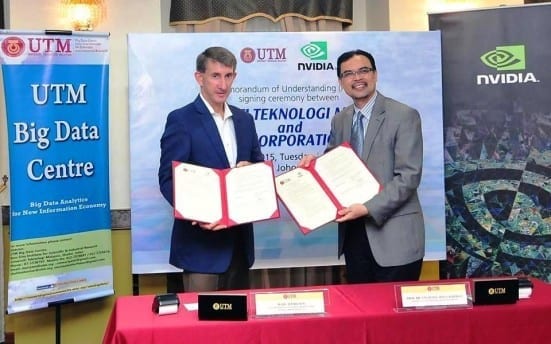 Prof. Azlan (right) and Marc Hamilton showing the agreement documents after the signing ceremony held at Dewan Sultan Iskandar , Johor Bahru campus