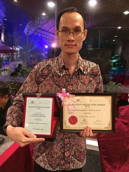 Assoc. Prof. Dr. Wong Kuan Yew showing his award certificate after the ceremony held at Aseania Spa & Resort, Langkawi, Kedah. 