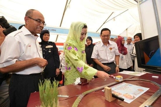 HRH Raja Zarith Sofia accompanied by UTM Vice Chancellor, Prof. Wahid Omar (most left) visiting one of the booths at UTMost Innovation Festival 2015 held in conjunction with UTM 30th Anniversary with State of Johor at Johor Bahru campus