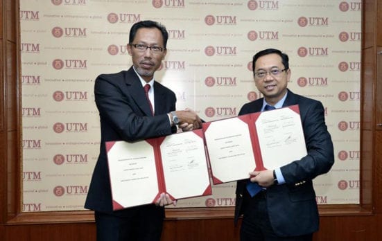 Abu Talib (right) exchanging documents with Prof. Fazi after the ceremony held at UTM Johor Bahru