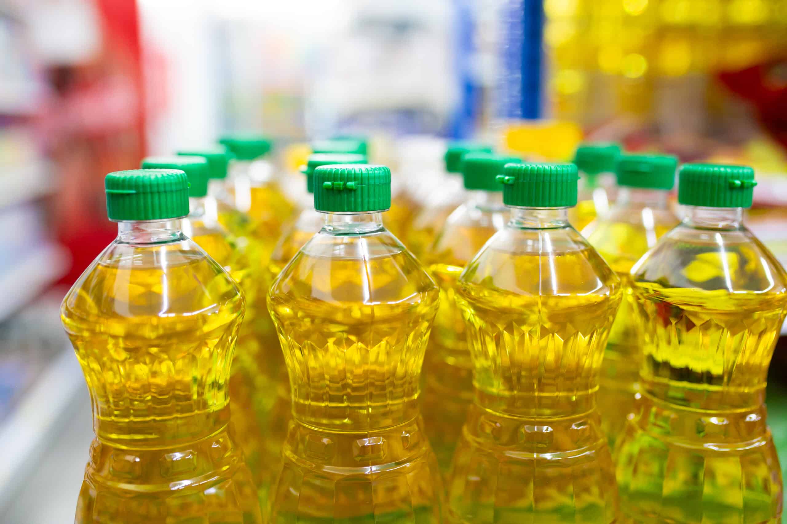 plastic bottles sunflower oil shelf supermarket closeup